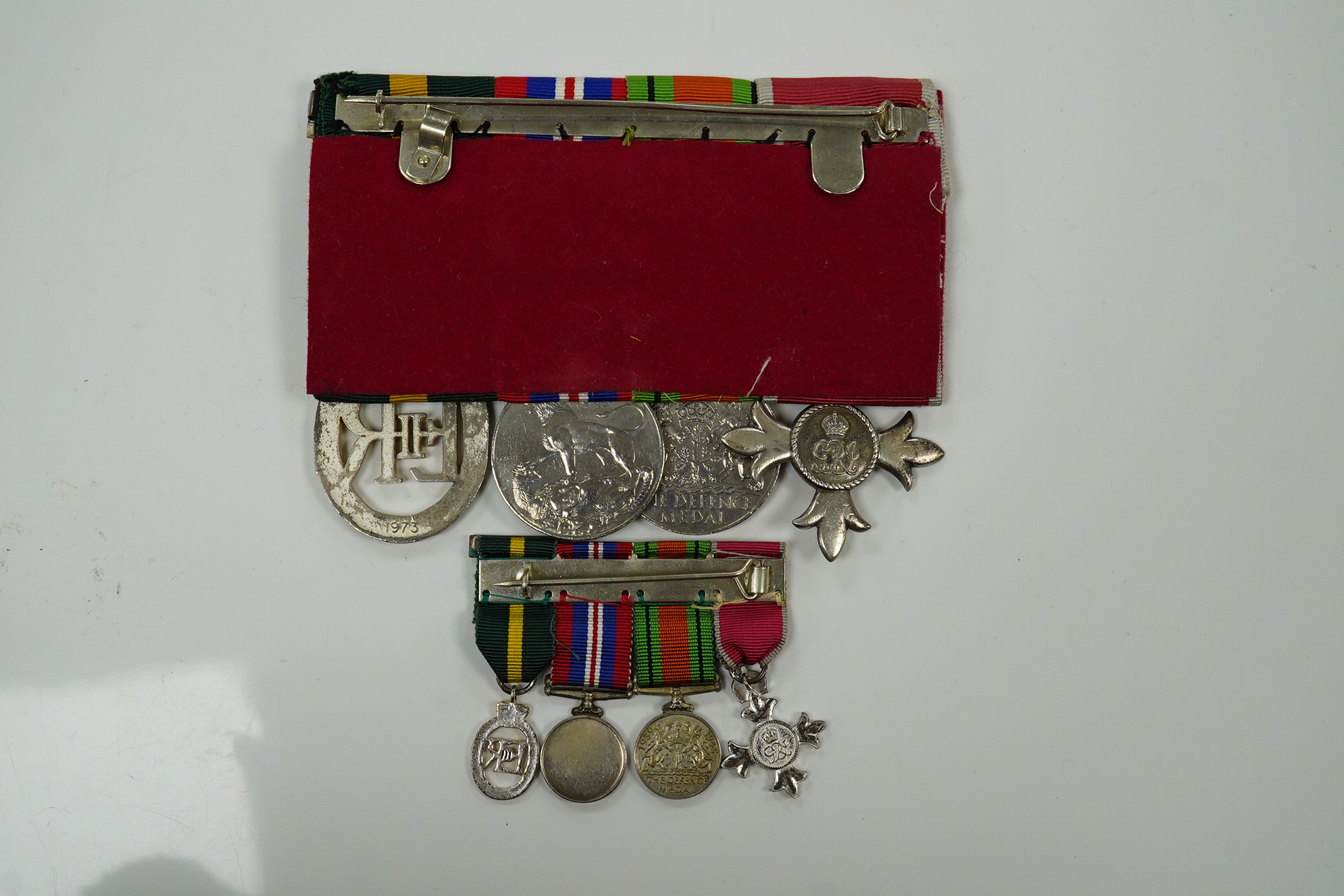 A group of 4 medals including MBE in display case